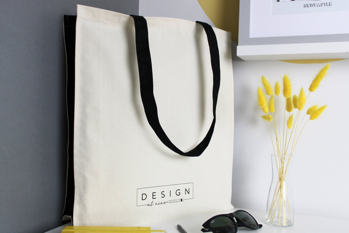 Leeds illustration featuring all the well known buildings and landmarks of the city on a 100% cotton canvas tote bag with black straps and side panels. The back of the bag feature the Design at Nine logo at the bottom.